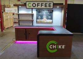 Custom Inline Exhibit with Shelves, Storage, Puck Lights, LED Accent Lights, and 3D Header and Logo