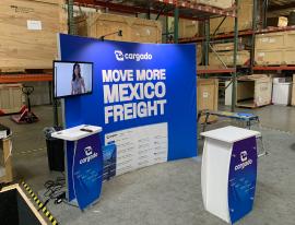 RENTAL: RE-1094 Inline Design with SYM-501 Symphony Curved Backwall with Baseplates, SYM-401 Backwall Workstation with Wireless Charging Ports, Monitor Mount, RE-1255 Reception Counter, (2) LED Arm Lights -- View 2